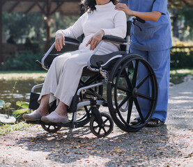 Obraz premium Asian young woman nurse at nursing home take care disabled senior man. Caregiver doctor serve physical therapy for older elderly patient to exercise and practice walking on walker or cane at backyard.