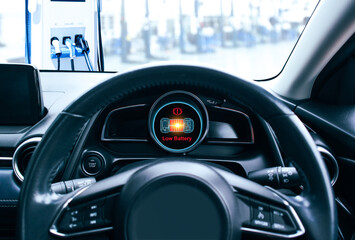 Low battery caution display on screen of a electric car instrument panel, The battery voltage...