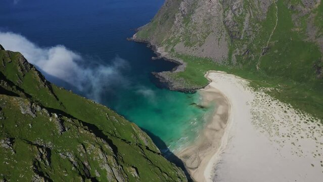 Cinematic downward angle drone shot Horseid Beach with turquoise blue water. Beautiful private beach. Northern side of Moskenes&oslash;y, in the western part of Lofoten
