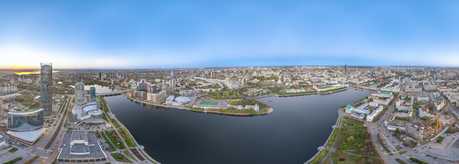 Yekaterinburg city and pond aerial panoramic view at summer or early autumn sunset. Night city in the early autumn or summer.