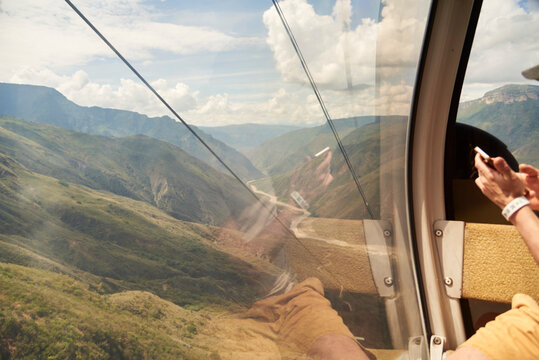 Unrecognizable person inside a cable car cabin in the Chicamocha Canyon.