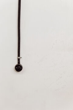 Black wire of socket on white wall