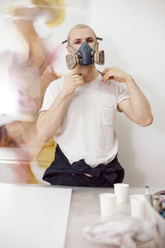Artist wearing respirator before work