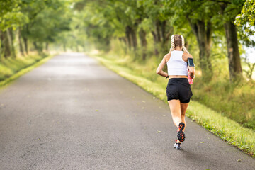 Rear view of a female runner training in nature