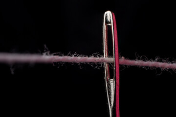 closeup photo of sewing thread in needle hole