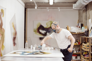 Man working on art piece in studio