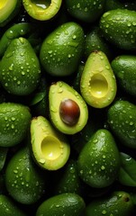 From above, a top view of a fresh avocado with delicate water droplets, the dark background enhancing its visual impact.