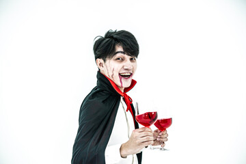 Asian man wearing Halloween costume as witch in red cloak, on white background, Dracula holding red...