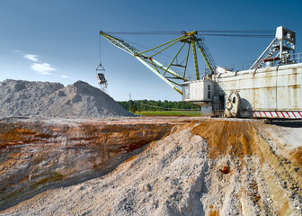Walking excavator takes chalk with bucket in open quarry © nordroden