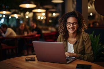 Latte Luminance: Eyeglass-Adorned Lady Finding Joy in Laptop Tasks within Cafe Confines 