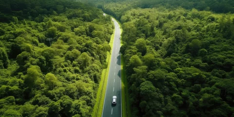 Poster Aerial view road in the middle forest, Top view road going through green forest adventure, Ecosystem ecology healthy environment road trip travel. © Sasint