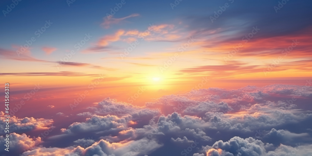 Wall mural beautiful sunset sky above clouds with dramatic light. cabin view from airplane