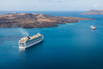 Santorini island, Greece. Cruise ship near the coast. Blue sea and the blue sky. - Powered by Adobe