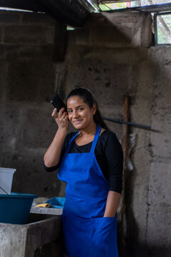 Woman listening a voice message in a rural kitchen while working