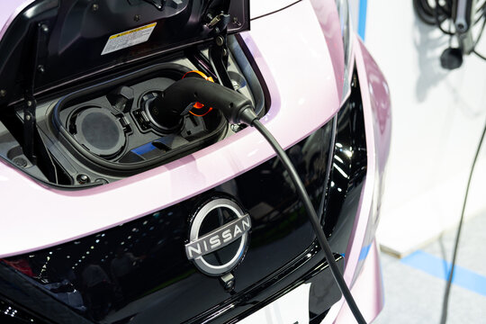 Bangkok Thailand AUG 29 2023: Nissan Leaf, Electric vehicle, plugged in with EV charger device.