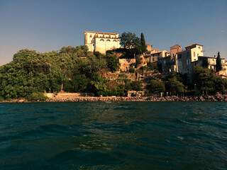 Kayak point of view of view of beautiful and picturesque village of Anguillara Sabazia located on the shores of Lake Bracciano