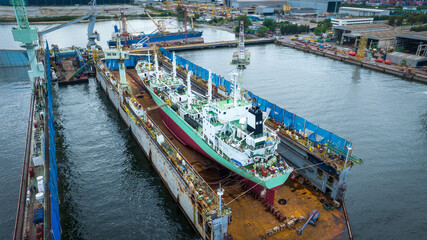 cargo container ship at dry dock concept maintenance service working in the sea. Insurance and...
