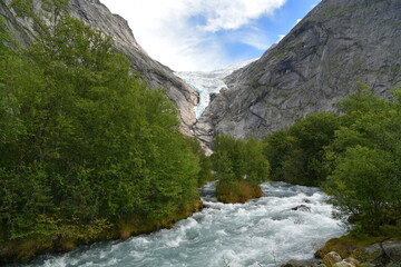 view of the glacier gorge in the background and the mountain river in the foreground