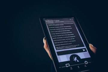 Biracial businesswoman using tablet with copy space on black background