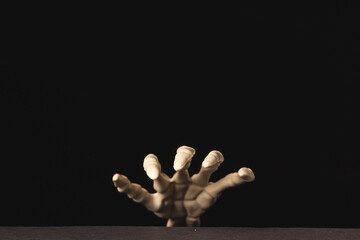 Plastic skeleton hand with copy space on black background