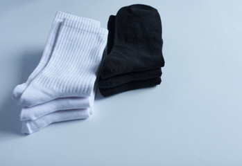 Pair of socks on a white background. Black and white socks. Selective focus.
