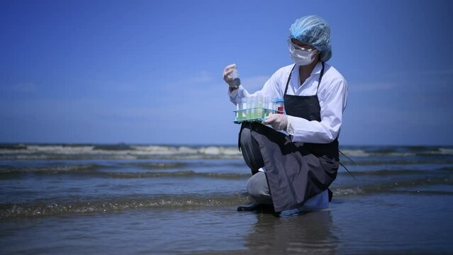 Scientist analysis wearing protective uniform,mask,glove and box under working water analysis effected from phytoplankton at sea ananly case in laboratory is environment pollution problem concept.	