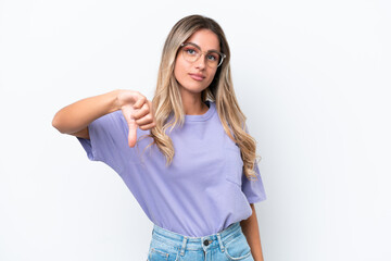 Fototapeta premium Young Uruguayan woman isolated on white background showing thumb down with negative expression