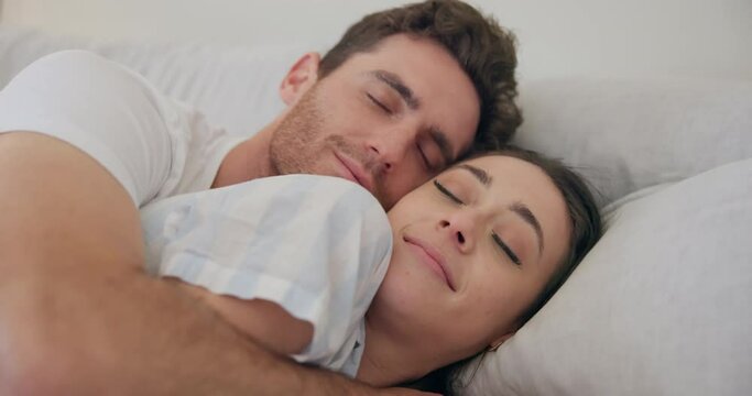 Couple, morning and bed to cuddle with love and hug for comfort, relax and wake up with a smile. A happy man and woman together in a home bedroom for health marriage, rest and good sleep for wellness