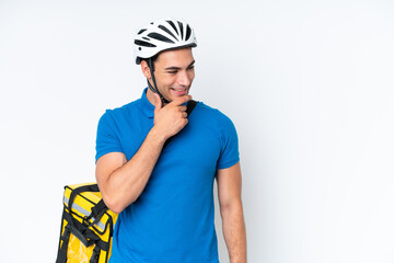 Young caucasian man with thermal backpack isolated on white background looking to the side