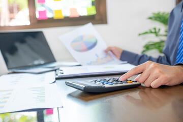 hand use calculator, businessmen plan strategies to increase business income