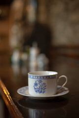 Fototapeta premium A cup of aromatic coffee in a white cup in a cafe on a table