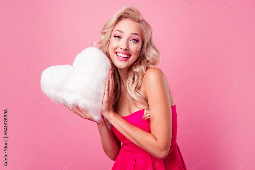 Sticker Portrait of lovely nice positive person arms hold fluffy soft heart toothy smile isolated on pink color background