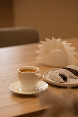 A cup of aromatic coffee in a white cup in a cafe on a table