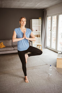 Young Woman Practicing Yoga in Her Apartment