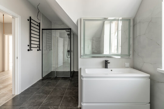 Bathroom in a modern house with black ceramic tiles on the floor