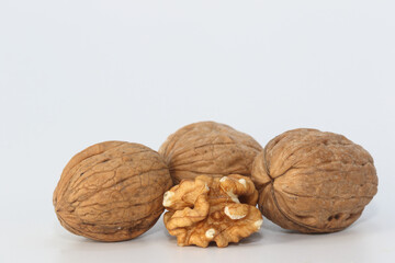 walnut kernel and whole walnuts on white background	
