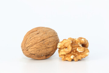 walnut kernel and whole walnuts on white background	
