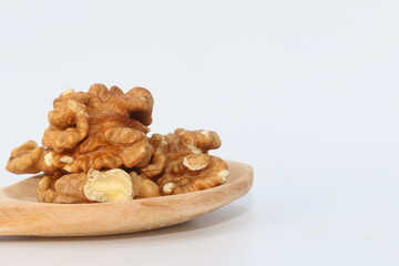 walnut kernel and whole walnuts on white background