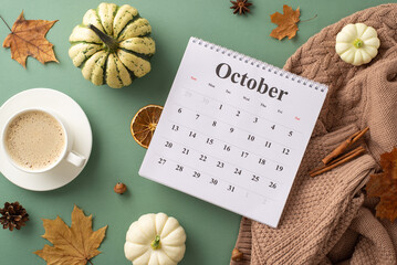 Welcoming autumn spirit. Top view shot featuring calendar with October month, sweater, steaming...