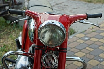 the front of the old original iron red with a glass headlight, steering wheel and signal of a heavy...