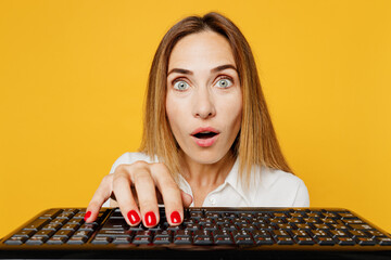 Close up young surprised woman she wears white shirt casual clothes typing on pc computer keyboard...