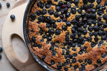 Fresh baked blueberry pie in a baking pan from above. Closeup