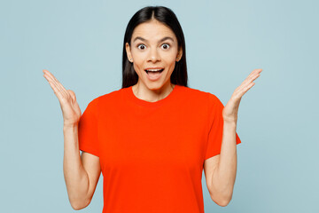 Young overjoyed excited latin woman she wear orange red t-shirt casual clothes look camera spread...