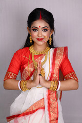 Portrait of a pretty young Indian girl wearing a traditional saree, gold jewellery, and bangles...
