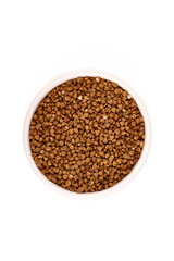 Raw buckwheat heap, isolated on white background.