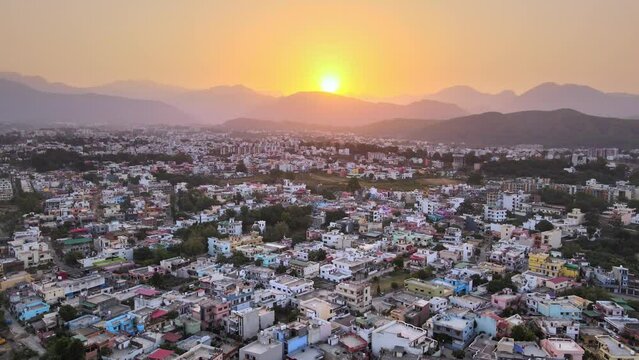 Beautiful landscape at sunrise through mountain top with houses and rooftops in Dehradun. Sunrise in Dehradun.