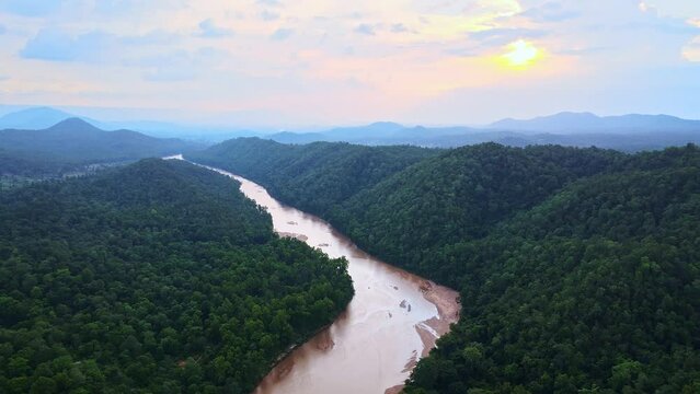 Aerial view of Koel river passing through Palamu tiger Reserve at Gotang Forest in Jharkhand. Drone shot neat Maoist forest in Jharkhand, India. Sunset over dense forest with river and dramatic sky