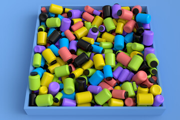 Pile of multicolor plastic jar for sport nutrition protein powder on blue