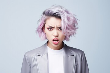 Anger Asian Woman In A Gray Jacket On Pastel Background . Сoncept Asian Women In Gray, Anger Expressions, Pastel Backgrounds, Womens Fashion