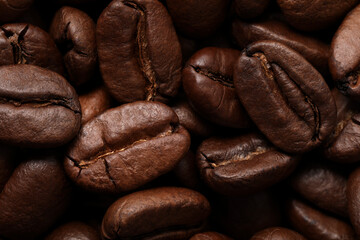 Naklejka premium Aromatic roasted coffee beans as background, closeup